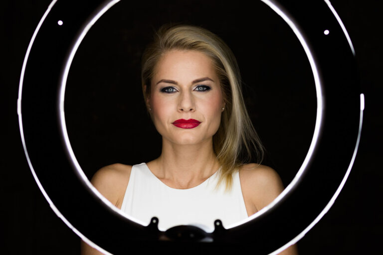 A woman in front of a ring light