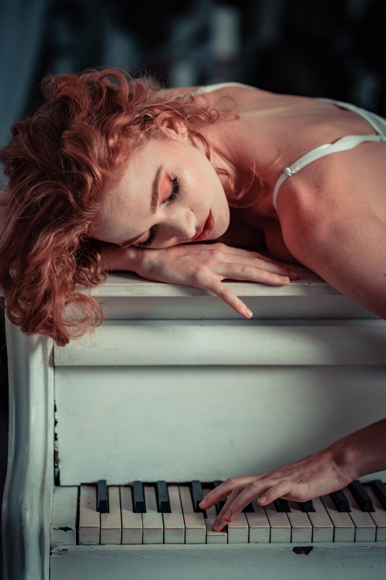 A young woman plays piano in lingerie by Attila Kapodarca